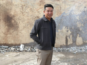 EVP, Chris Chong, headshot, against steel plate.