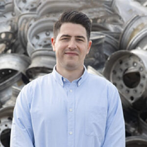 VP, Bret Penninger, headshot, against pile of scrapped wheels.