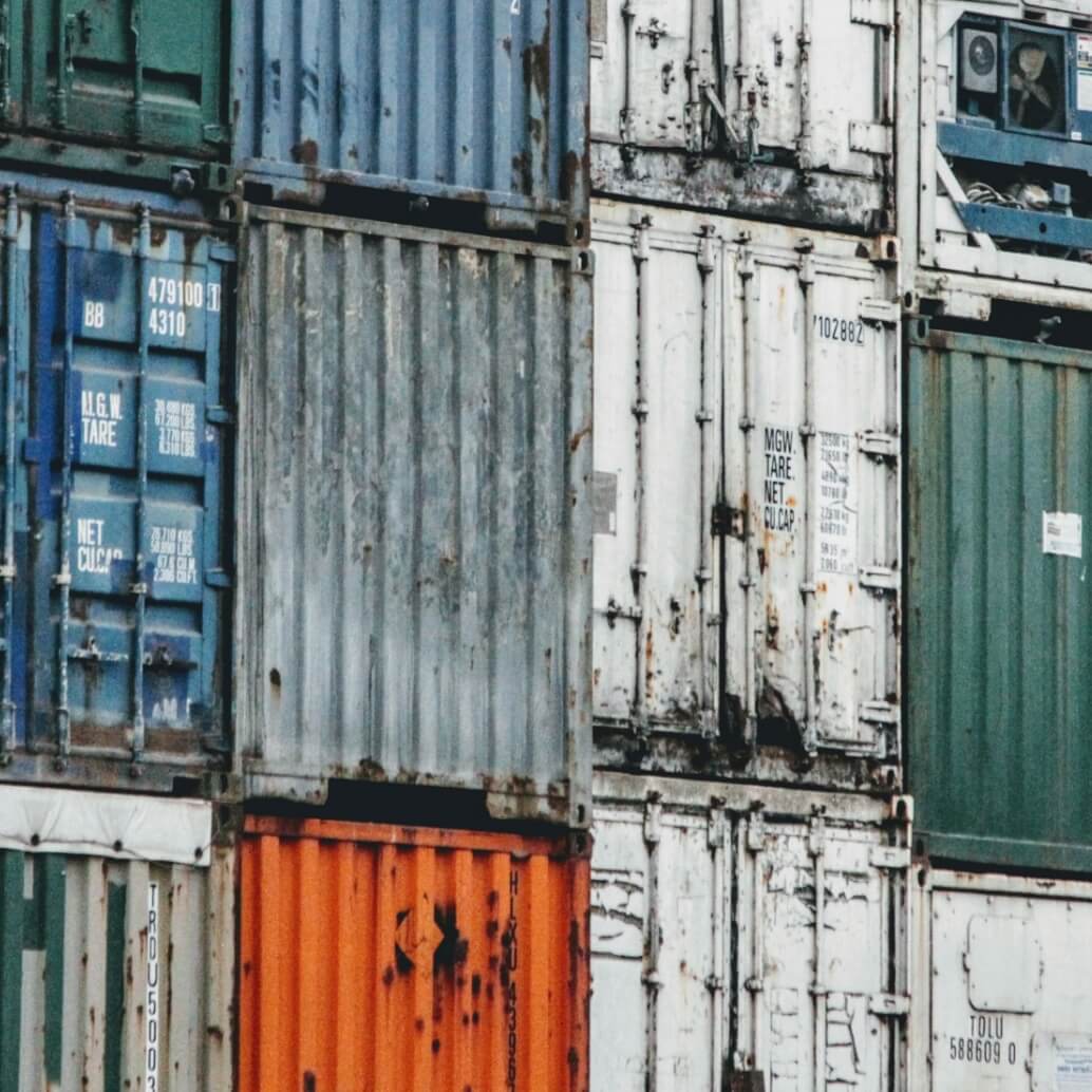 Close-up of stacked multi-colored shipping containers.
