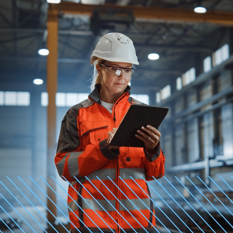 Female worker in PPE working on a tablet.