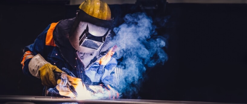 Welder in PPE welding.