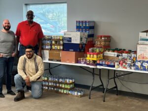 Dallas team with large, 2022 canned food drive collection.
